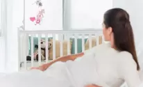 baby-crib-near-blurred-woman-lying-on-bed-2023-11-27-04-59-21-utc.jpg.webp