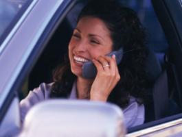 happy-woman-on-phone-while-driving-422x280