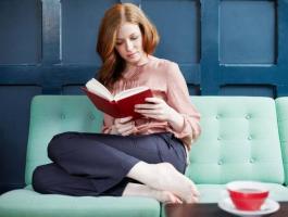 woman-reading-a-book-on-sofa-jpg-3836749611509671.jpg