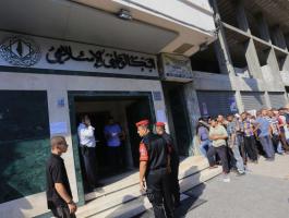 البنك الوطني يوافق على إعادة خصومات موظفي غزة