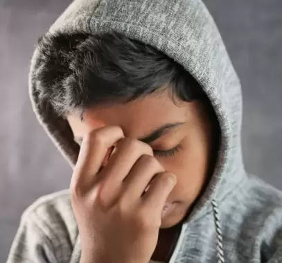 sad-teenage-boy-covering-his-face-sitting-on-sofa-2023-11-27-05-16-52-utc_0.jpg.webp
