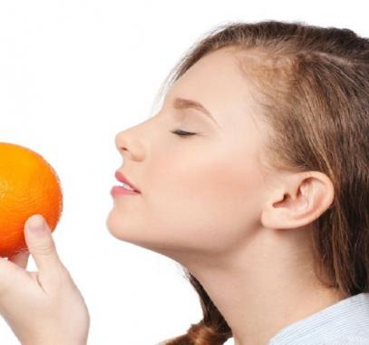 woman-smelling-orange-fruit-jpg-36056014433824142