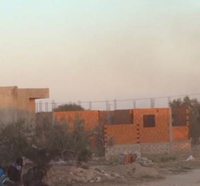 160303012827_people_shelter_from_the_gun_fire_outside_a_house_in_el_aouija_outside_ben_guerdane_640x360_ap_nocredit