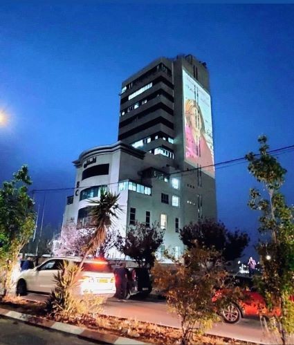 بالصور: إضاءة برج "تلفزيون فلسطين" بصورة شيرين أبو عاقلة